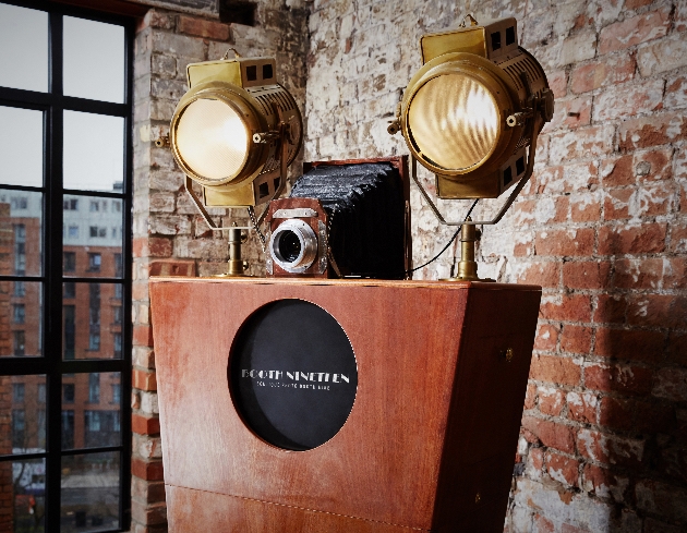 Vintage style photo booth from Booth 19 against exposed brick wall