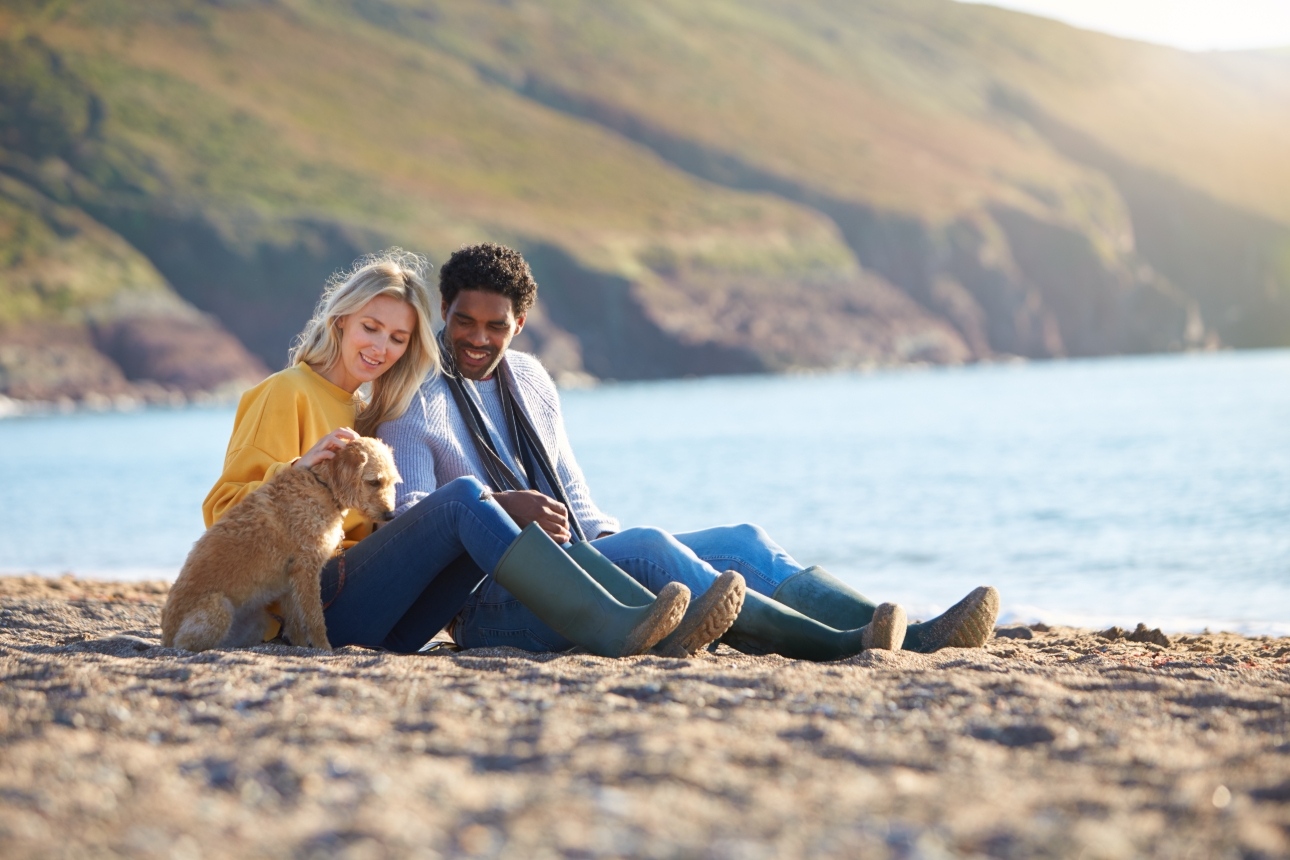 couple with dog on beach 