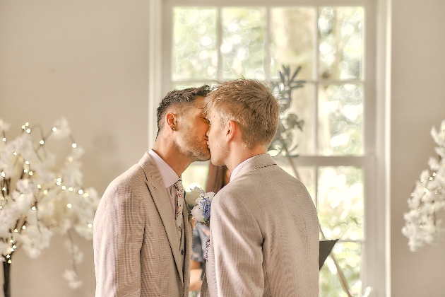 couple kiss after exchanging their wedding vows