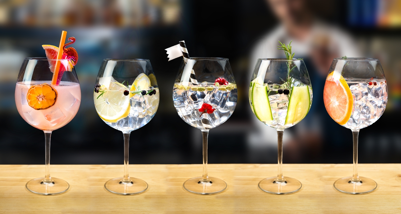 a selectin of gin cocktails lined up on a bar