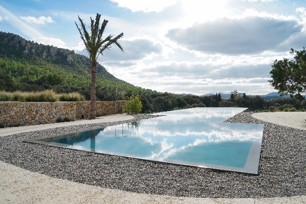 outdoor pool, square shape with infinity effect, mountains in the background