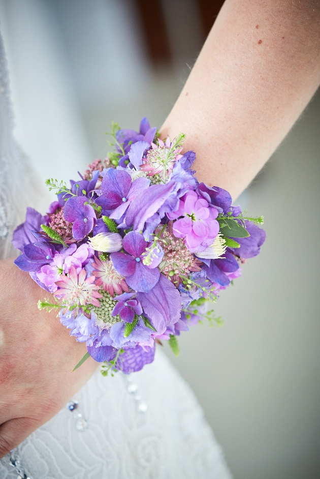 purple flower corsage on wrist
