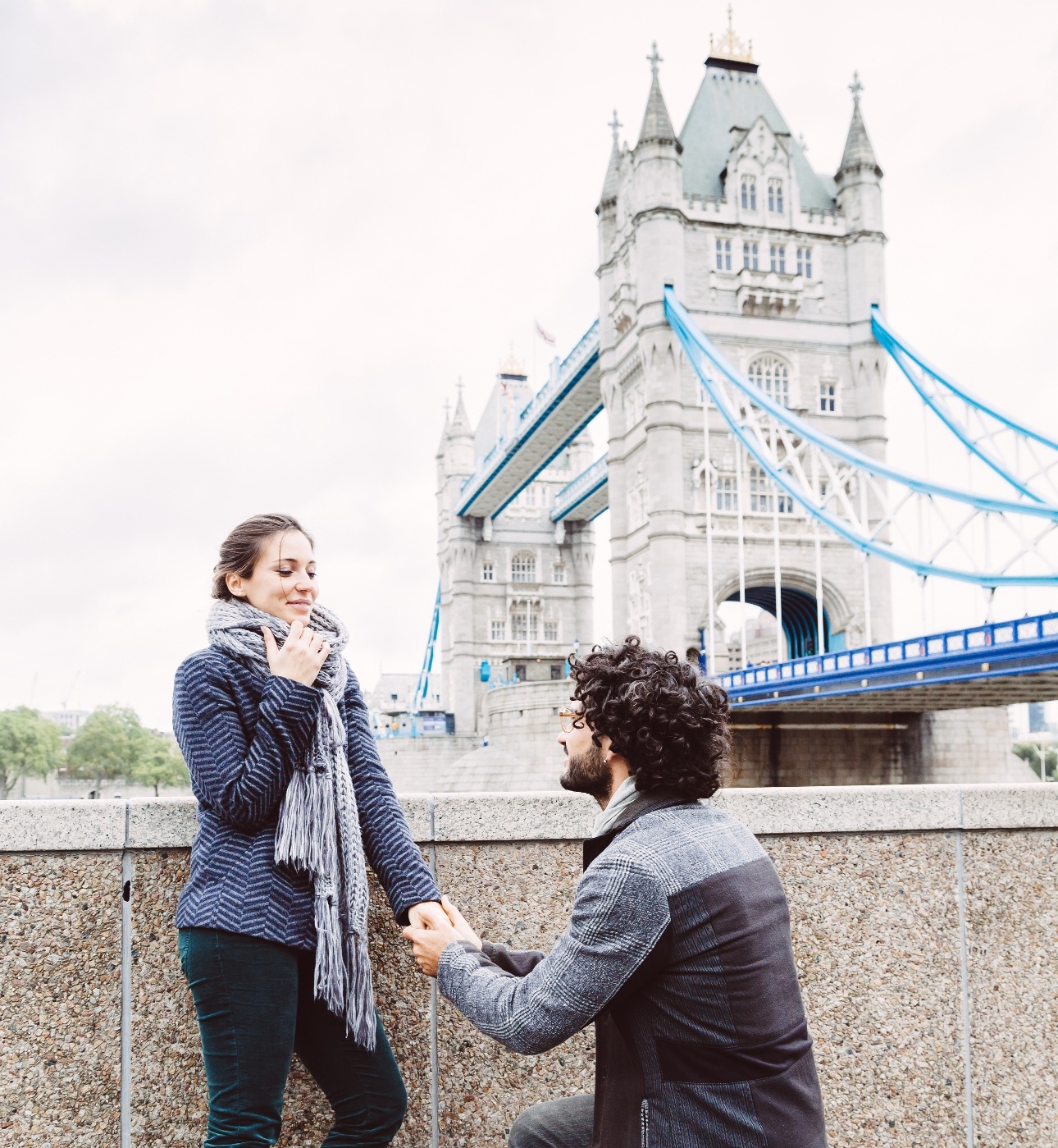 man proposing by the River Thames with London's Tower Bridge in the Background
