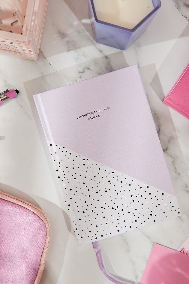 Pink and white diary on a table.