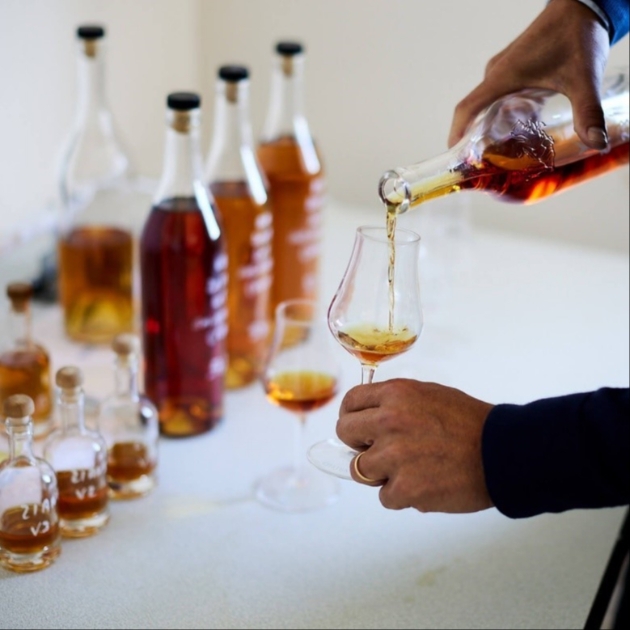 someone pouring brandy for a tasting masterclass