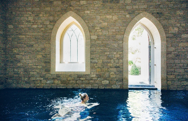 Woman swimming in the blue waters of the pool at The Royal Crescent Hotel & Spa