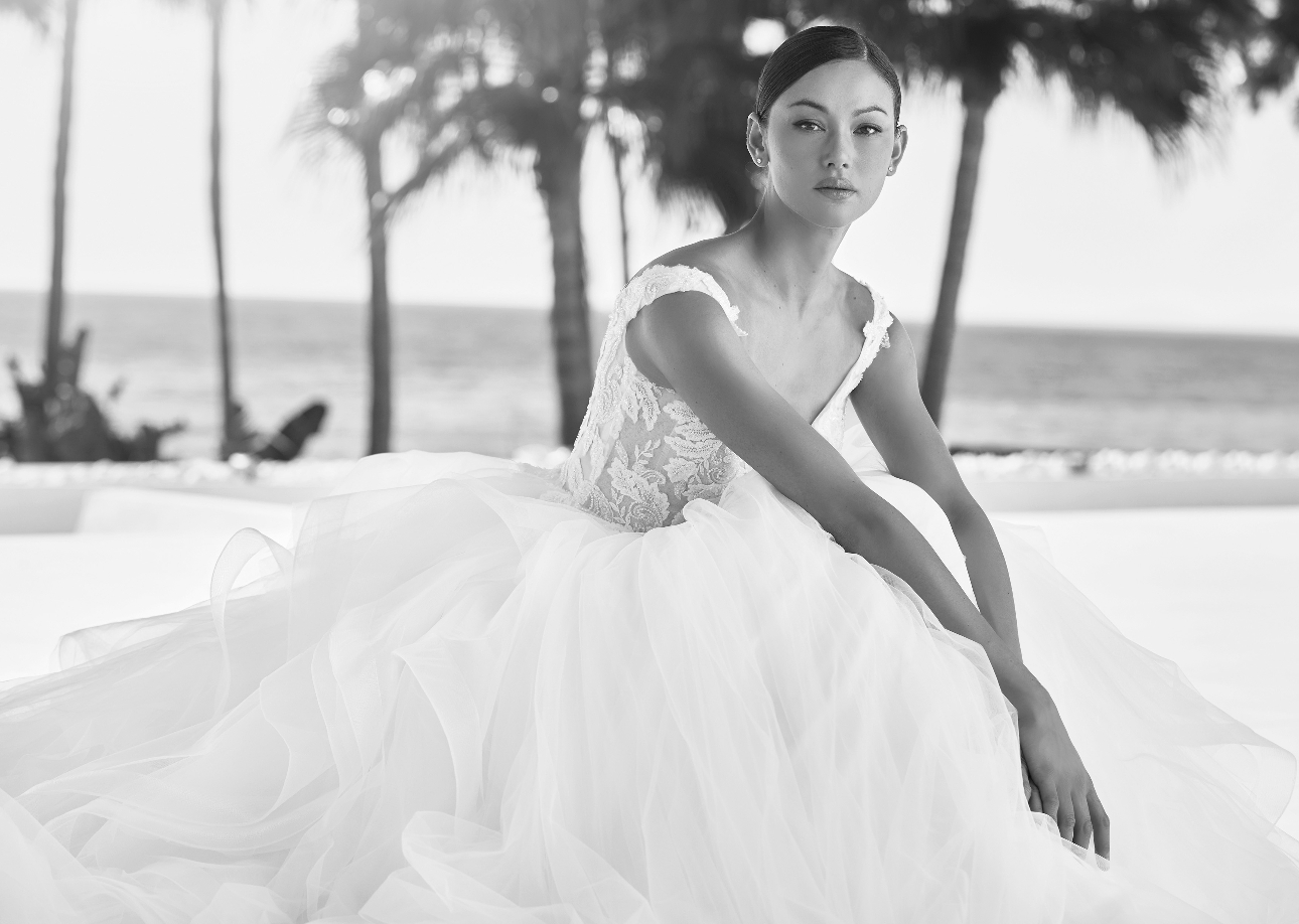 black and white image of model in white princess dress with big layered skirt