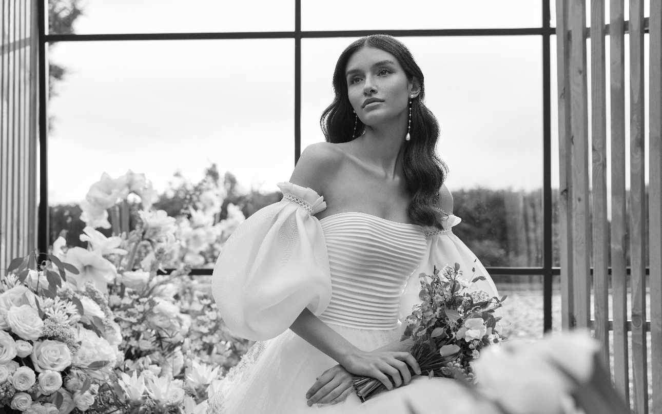 black and white image of model in wedding dress, ribbed corset, vintage style volume sleeves off shoulder