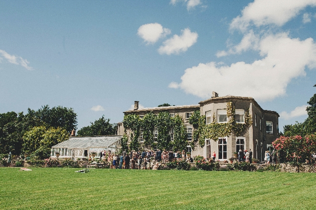 Exterior of Pennard House with wedding guests gathered outside