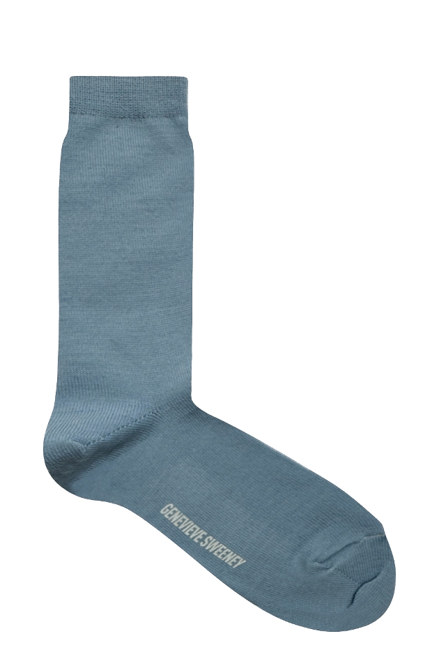 A light blue sock with Genevieve Sweeney written on the bottom